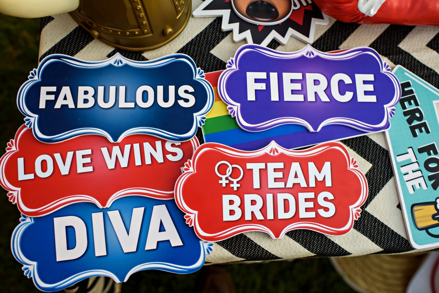 Photo booth props at a gay wedding.